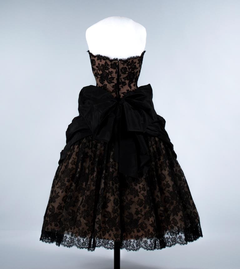 Image of Woman's black lace evening gown, over pink-orange taffeta, 1957